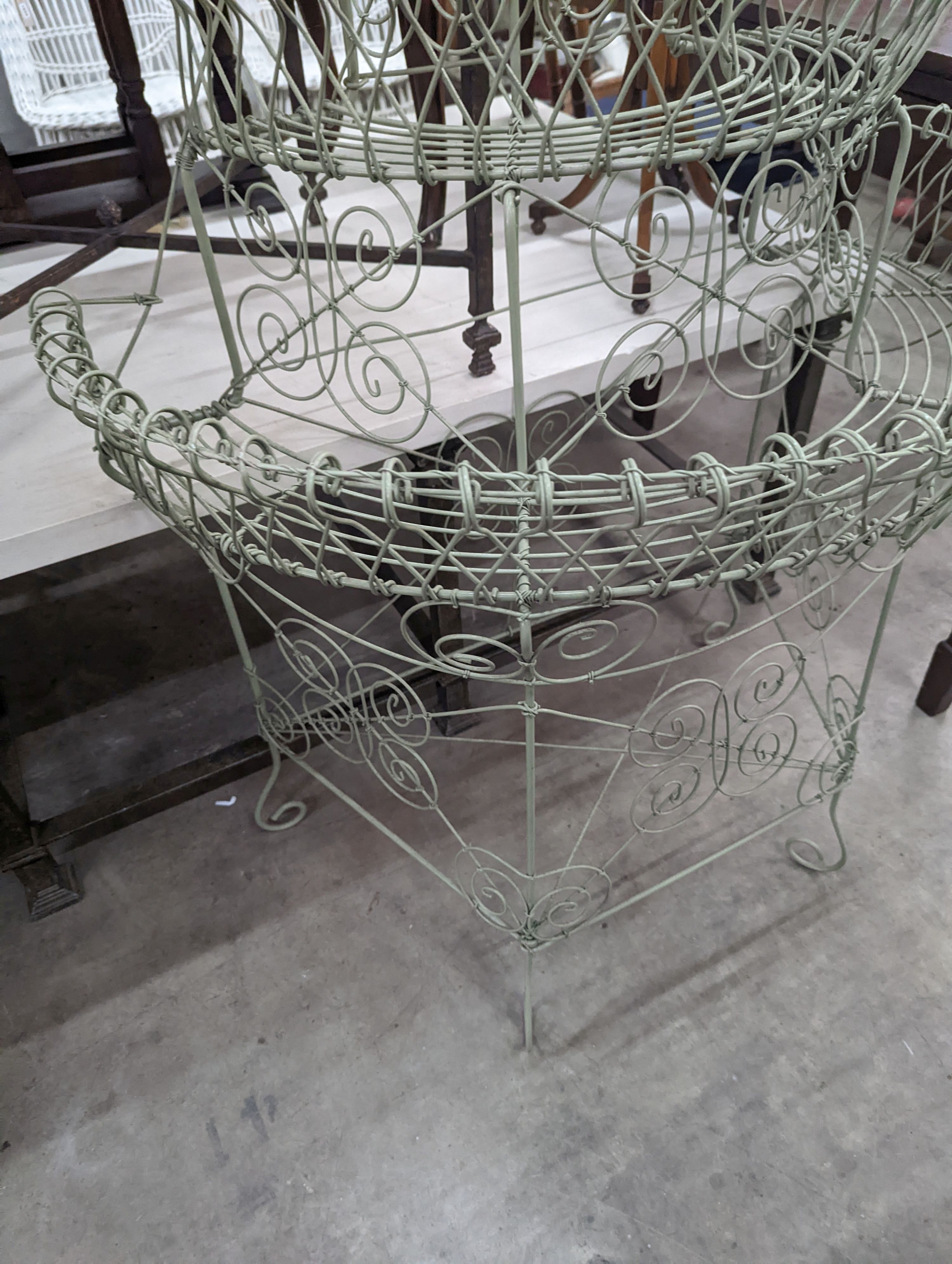 A Victorian style painted wirework plant stand, width 84cm, depth 54cm, height 130cm